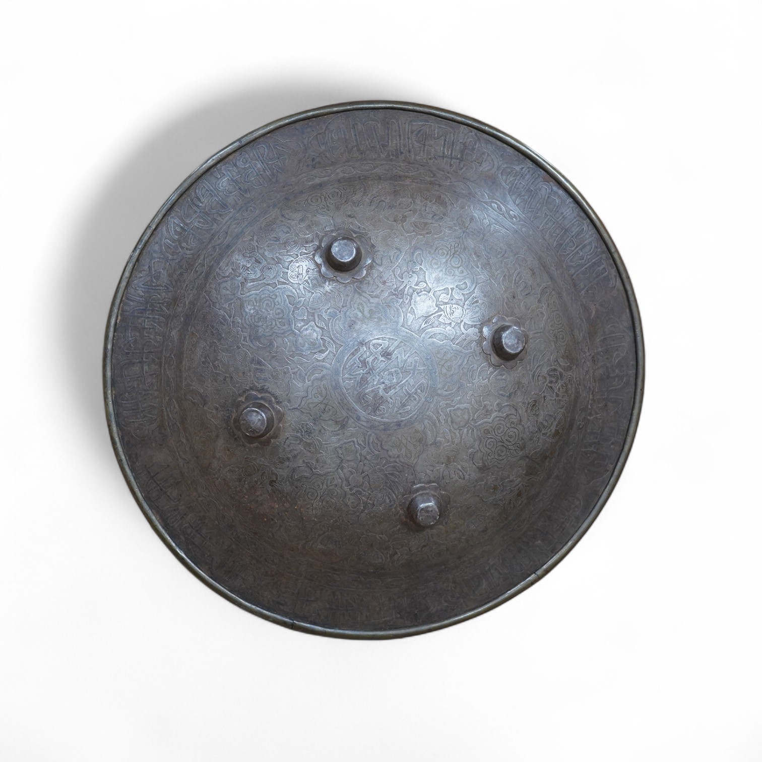 An early 20th century Persian steel shield dhal, 47cm diameter, with pairs of seated figures, brass reinforced brim, four central bosses, and silver and brass Damascene decoration, and four Burmese pottery vessels and a